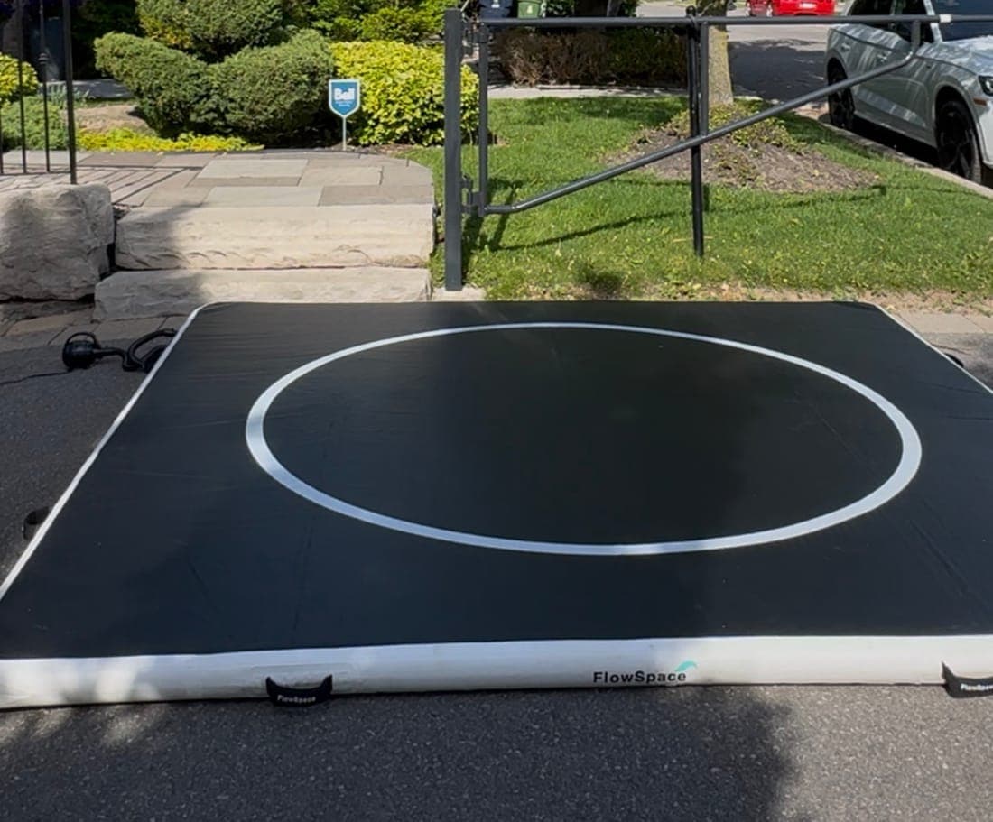 A 10 by 10 FlowMat inflated on a driveway in front of a house